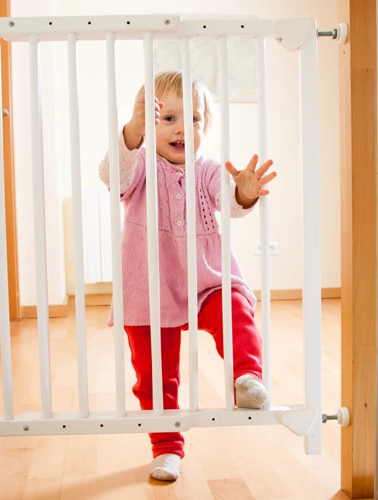child behind childproof gate