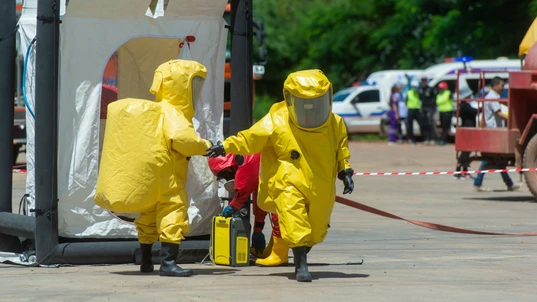 Firefighters with hazmat (hazardous material) suits to protect them from dangerous chemical work.